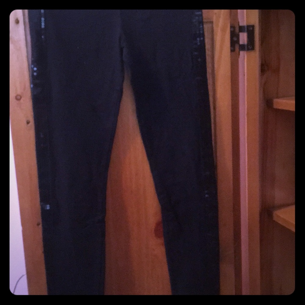 Black leggings with sequins down the legs.